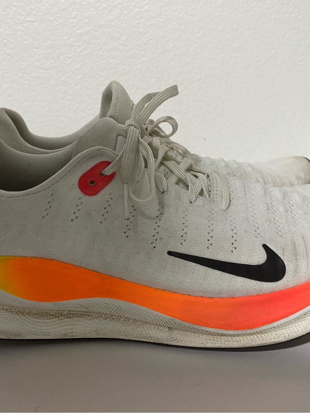 Nike Men’s White Athletic Shoes with Neon Orange and Black Accents